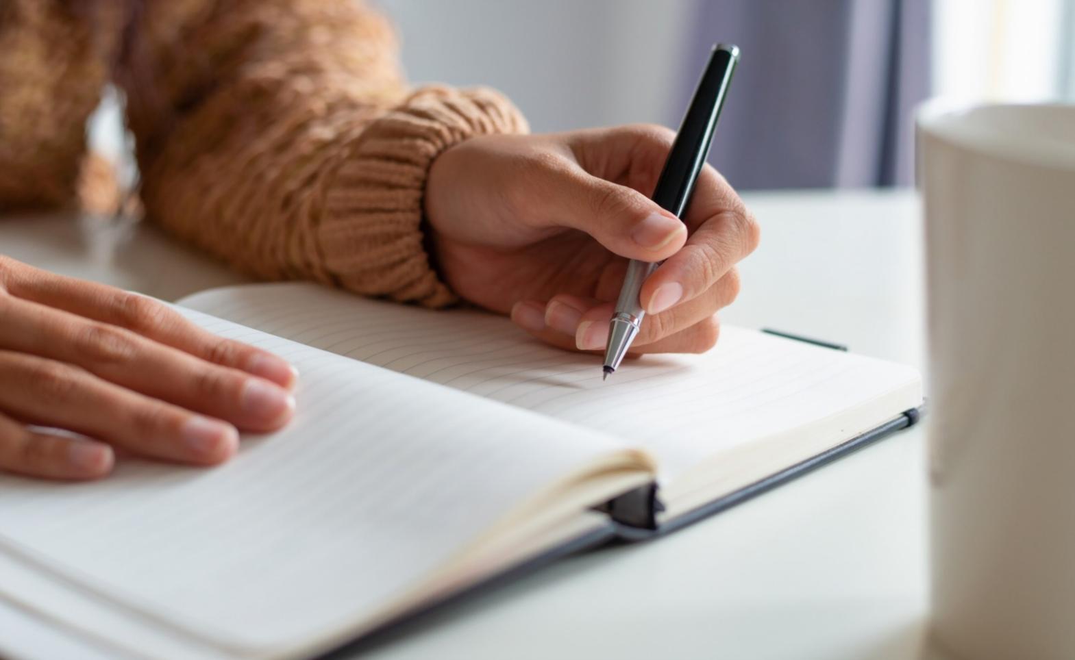 Person reviewing financial documents and planning budget strategies
